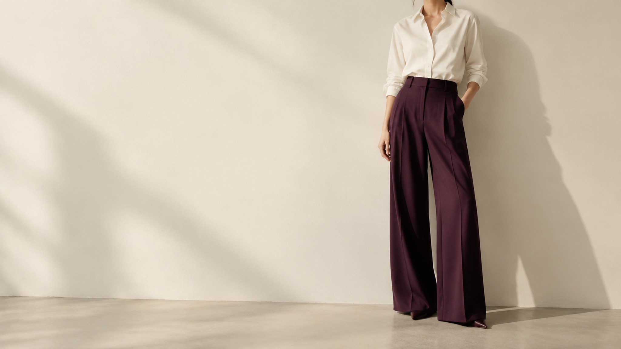 A crisp ivory shirt styled with tailored wide-leg trousers